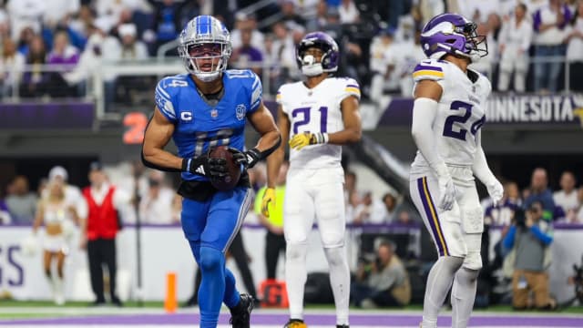 Detroit Lions wide receiver Amon-Ra St. Brown celebrates a touchdown against the Minnesota Vikings.
